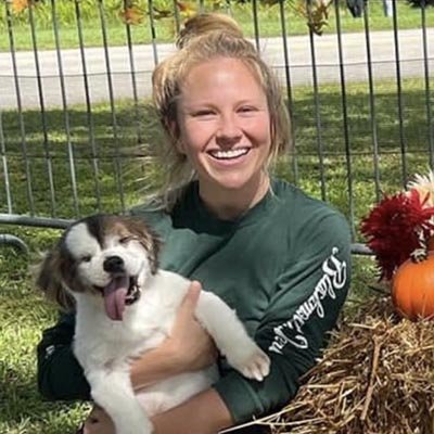 Dog sitter in Coconut Creek is holding a cute dog in her arm.