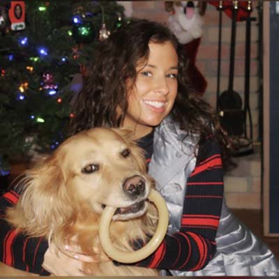 dog-walker-in-margate Dog walker is front of a Christmas tree with her golden retriever.