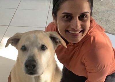 A dog walker with her labrador retriever dog.